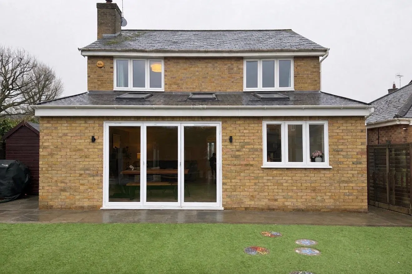 Completed two-storey rear extension with dormer windows, rooflights and full-width bifold doors