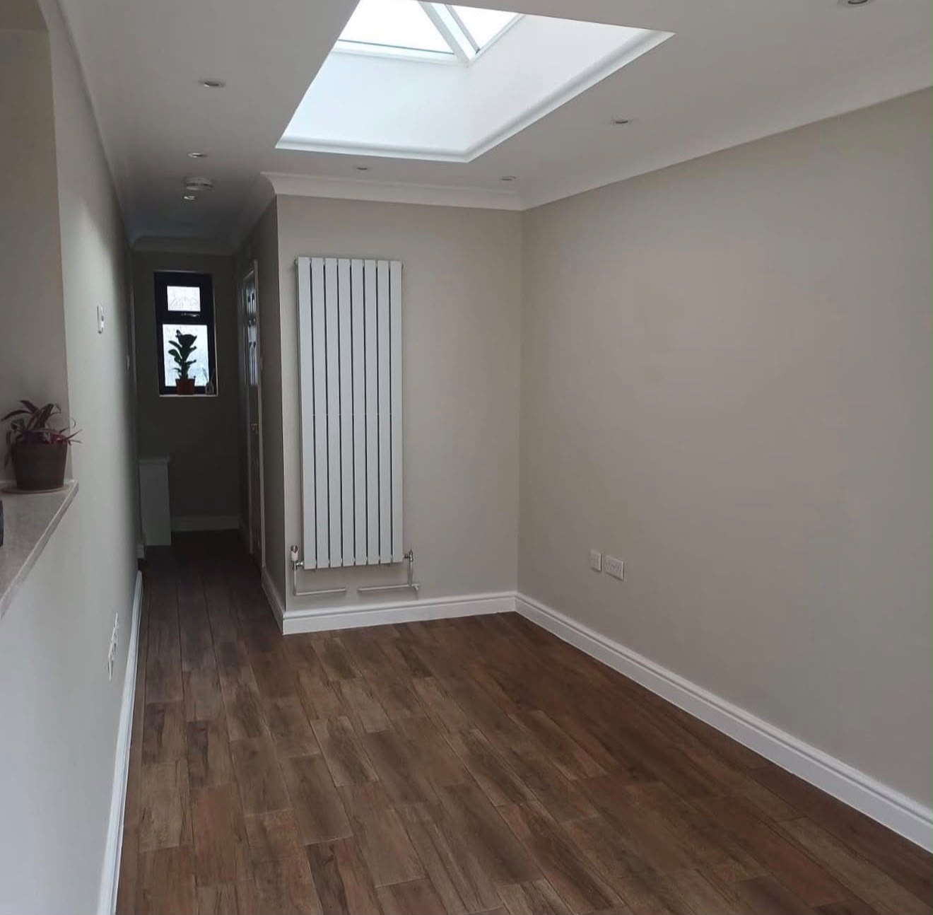 Newly refurbished open-plan interior with rooflight and column radiator
